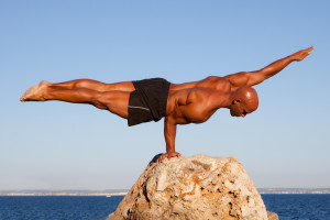 balance strong man balancing on rock.